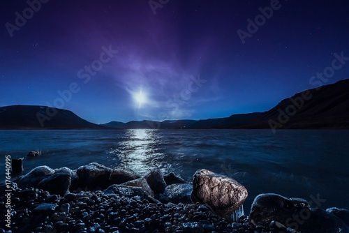 Landscape of a nature of a night with moon in the mountains of Spitsbergen Svalbard near the Norwegian city Longyearbyen