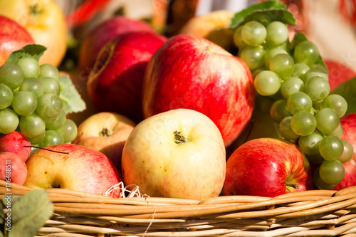 ripe apples with grapes in a basket