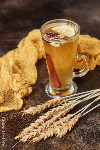 Compote with lemon and cinnamon on rustic wooden background