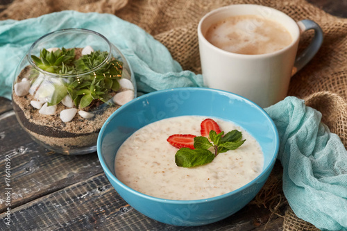 Oatmeal with cup of latte coffee. Breakfast