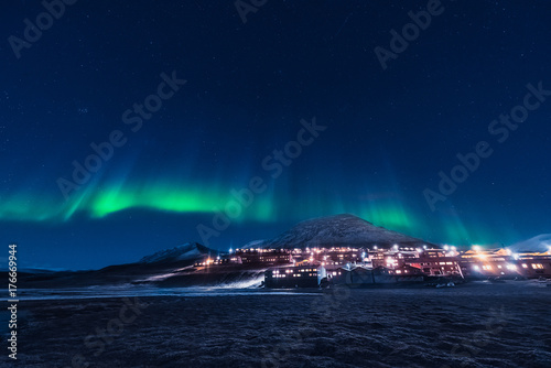 The polar arctic Northern lights aurora borealis sky star in Norway Svalbard in Longyearbyen the moon mountains