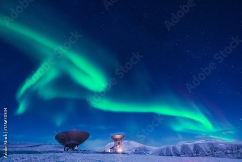 The polar arctic Northern lights aurora borealis sky star in Norway Svalbard in Longyearbyen the moon mountains