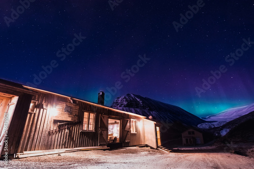 The polar arctic Northern lights aurora borealis sky star in Norway Svalbard in Longyearbyen the moon mountains