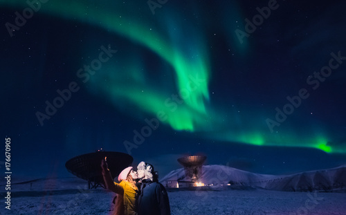 The polar arctic Northern lights aurora borealis sky star in Norway Svalbard in Longyearbyen man the moon mountains