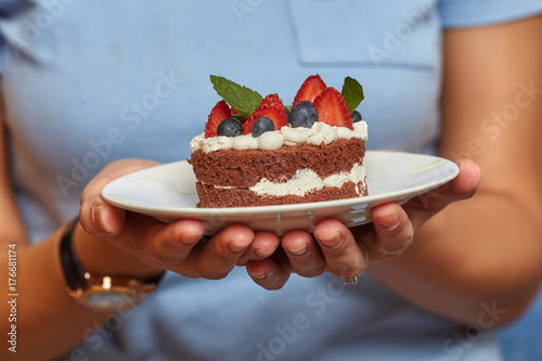 Hans with chocolate cake with cream and berries