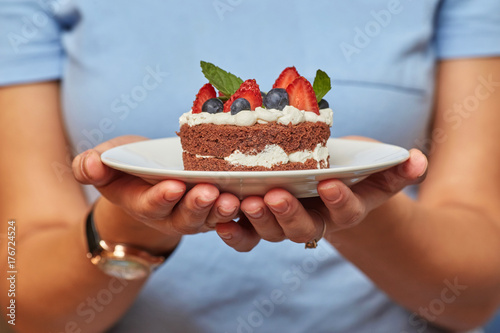 Hans with chocolate cake with cream and berries
