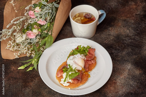 Breakfast of pancakes with salmon and egg florentine