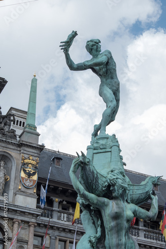 Brabo Fountain, copper sculpture of Brabo, Roman mythological figure, throwing the hand of the giant into the river. Brabo Fountain in Grote Markt, the town square in the city centre, Antwerp, Belgium
