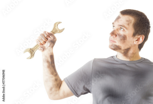 dirty mechanic man holding wrench tool for repair