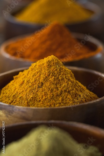 Various spice powder on wooden table