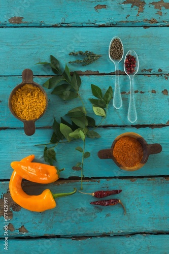 Various spices and herbs on wooden table