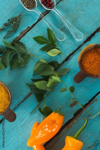 Various spices and herbs on wooden table