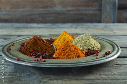 Various type of spices in plate on wooden table