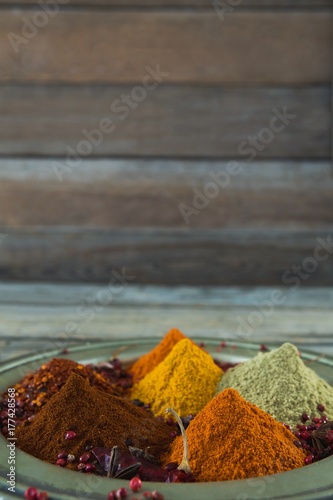 Various type of spices in plate on wooden table