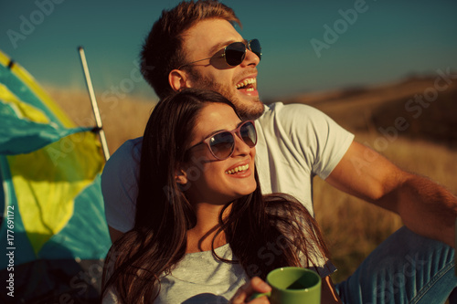 Happy young couple enjoys a sunny day in nature