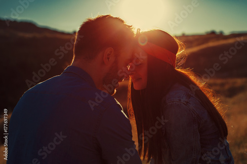 Young loving couple enjoys the sunset