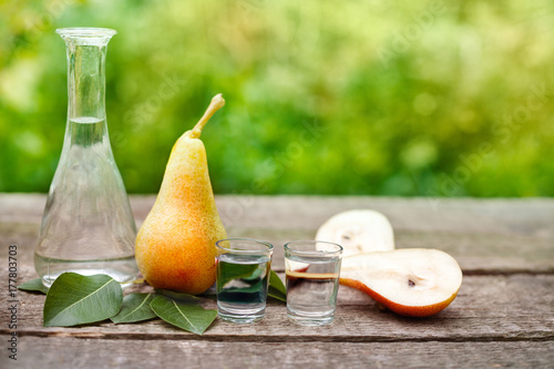 Fresh pears and shot glass with brandy