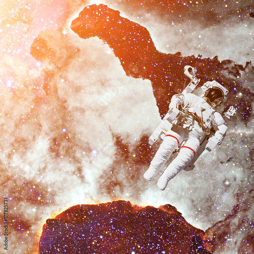 Astronaut in outer space. Nebula on the background.