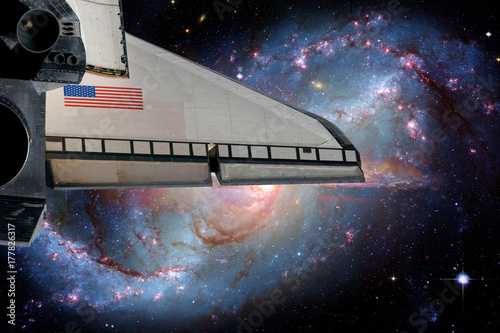 Space shuttle orbiting Earth planet. Elements of this image furnished by NASA