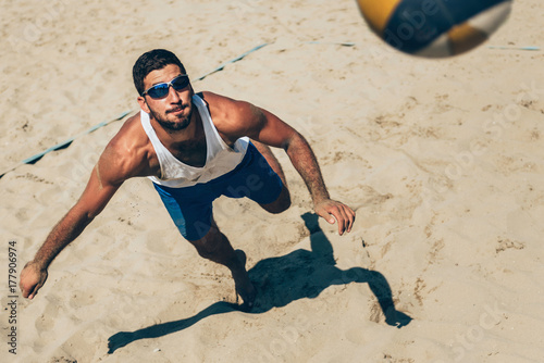 Beach volleyball Player about to hit the ball
