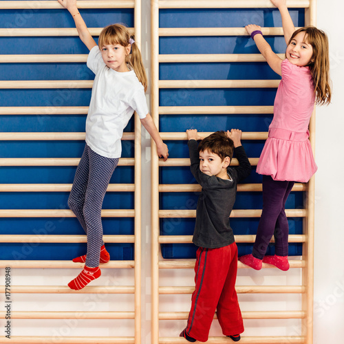 Children climbing wall bars