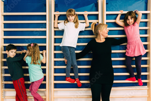 Children and physical therapist at corrective gymnastics