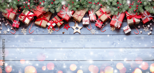 Rustic Gift On Wooden Table With Fir Branches And Snowflakes
