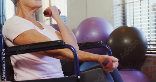 Senior woman exercising with dumbbells 