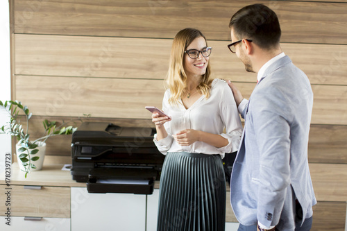 Business people talking in office by the scanner mashine