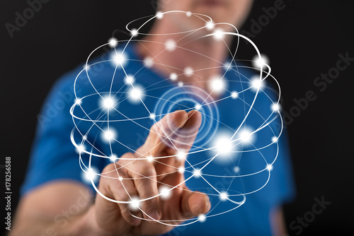 Man touching global connection on a touch screen