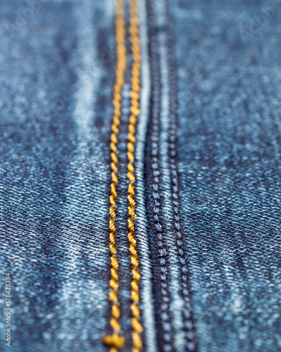 Stitches on blue jeans. Close up.