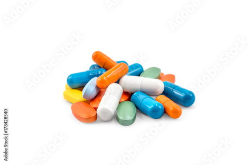 Heap of different colorful pills on a white.