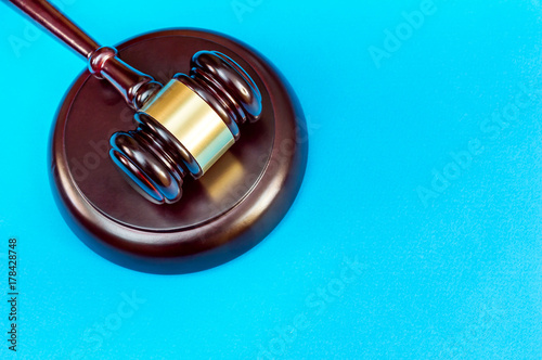 Wooden gavel with stand on a blue background. Justice background. Top view.