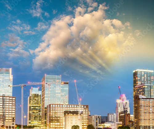Canary Wharf night skyline with Thames river reflections, London - UK