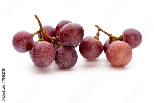 Ripe red grape isolated on white.