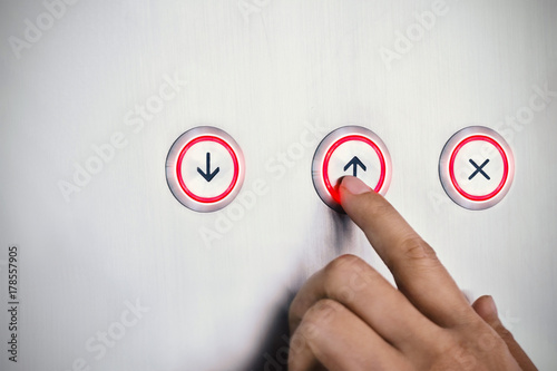 Hand push the button with red lighting, business symbolic concept
