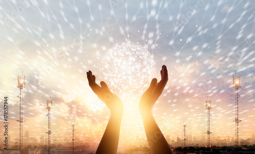 Businessman touching circle global network connection and data exchanges worldwide on city sunset background, communication and technology concept