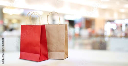 Red and brown shopping bags in mall store background