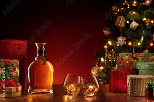 close up view  of  bottle and two glasses with whiskey on color back. 