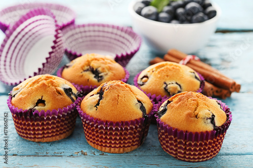 Sweet blueberry muffins on blue wooden table