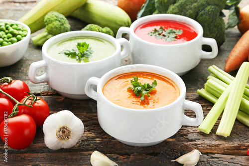Vegetable cream soup with parsley on grey wooden table
