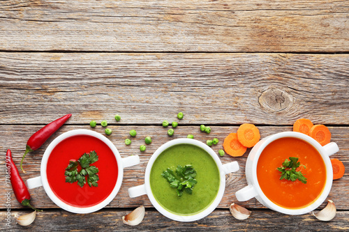 Vegetable cream soup with parsley on grey wooden table