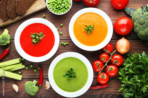 Vegetable cream soup with parsley on wooden table