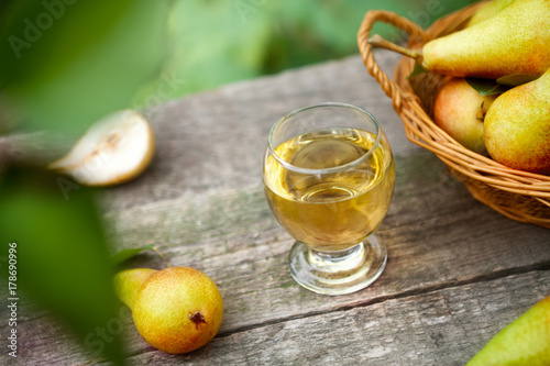 Fresh pear juice in glass on table