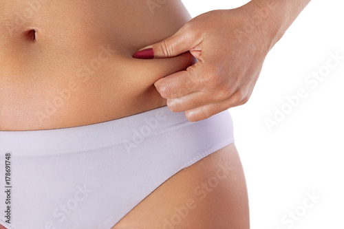 Womans belly fat pinched