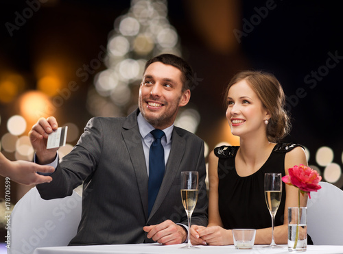 couple with credit card at christmas restaurant