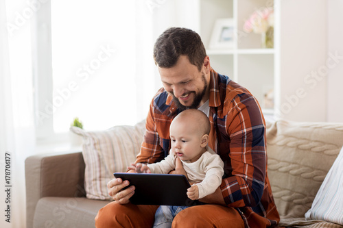 happy father and baby boy with tablet pc at home