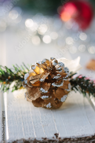 White christmas decoration - pinecone on wooden board.