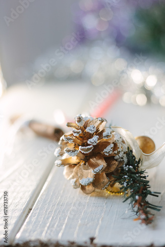 White christmas decoration - pinecone on wooden board.