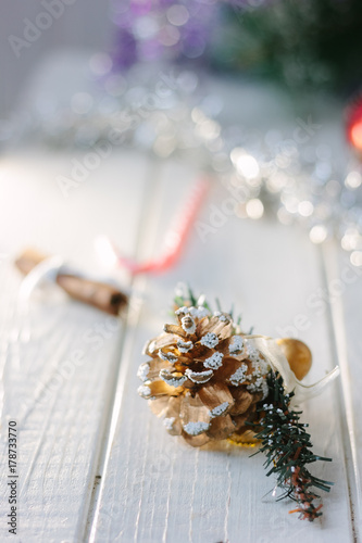 Pinecone on white wooden board as christmas decoration.